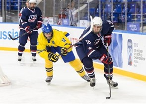 SOCHI, RUSSIA - APRIL 25: USA's Steven Santini #16 stickhandles the puck while being pursued by Sweden's Andre Burakowsky #12 during quarterfinal action 2013 IIHF Ice Hockey U18 World Championship. (Photo by Matthew Murnaghan/HHOF-IIHF Images)