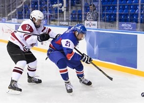 SOCHI, RUSSIA - APRIL 26: Latvia's Janis Jaks #21 and Slovakia's David Soltes #21 battle for the puck near the boards during relegation round action 2013 IIHF Ice Hockey U18 World Championship. (Photo by Matthew Murnaghan/HHOF-IIHF Images)